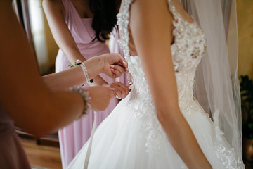Obraz na płótnie Canvas Morning of the bride when she wears a beautiful dress