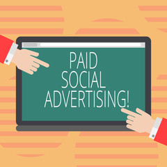 Word writing text Paid Social Advertising. Business concept for external marketing efforts involve a paid placement Hu analysis Hands from Both Sides Pointing on a Blank Color Tablet Screen
