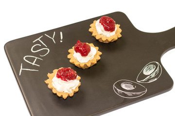 Three cheese cakes with raspberry dressing on the top