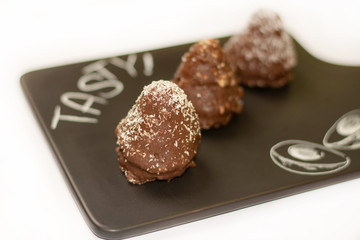 Three cone chocolate cakes on the tray with white background