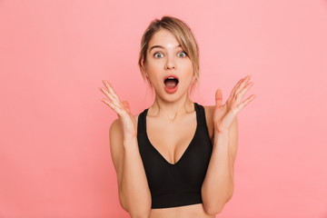 Shocked beautiful young sports blonde woman posing isolated.