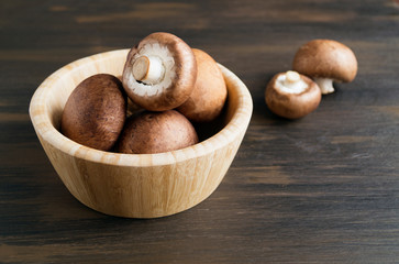 Fresh king brown mushrooms on wooden background.