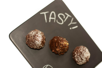 Three cone chocolate cakes on the tray with white background