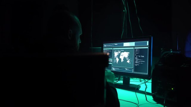 Wanted hackers coding virus ransomware using laptops and computers in the basement. Cyber attack, system breaking and malware.