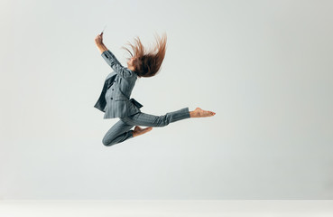 Happy business woman dancing and smiling in motion isolated over white studio background. Human emotions concept. The businesswoman, office, success, professional, , happiness, expression concepts