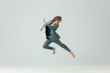 Obraz premium Happy business woman dancing and smiling in motion isolated over white studio background. Human emotions concept. The businesswoman, office, success, professional, , happiness, expression concepts