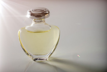 Bottle vintage of perfume illuminated laterally, conceptual image