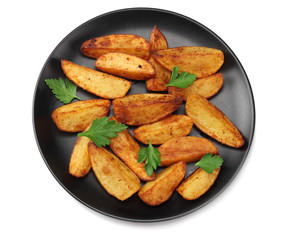 Fried potato wedges on black plate isolated on white background. top view. Fast food.