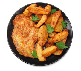 Fried potato wedges with schnitzel on black plate isolated on white background. top view.