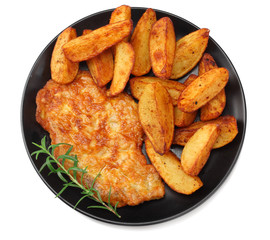 Fried potato wedges with schnitzel on black plate isolated on white background. top view.
