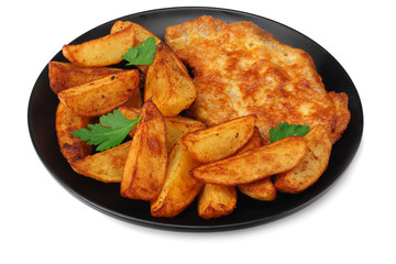Fried potato wedges with schnitzel on black plate isolated on white background