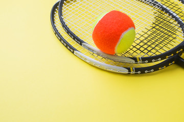 Tennis Ball and rackets on yellow Background, Sport Concept and Idea, © Elenglush
