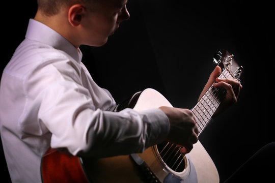 Young men playing the guitar