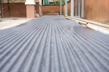 Zinc roof on floor preparing for installation in construction site © ApiFoto