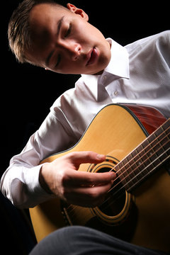 Young men playing the guitar
