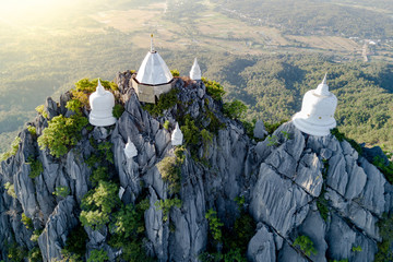 Spectacular aerial view of floating pagodas on the mountain cliff at Wat Chaloem Phra Kiat in Chae Hom District, Lampang province, Thailand. - obrazy, fototapety, plakaty