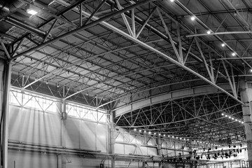 Interior of warehouse. large metal structures, ceiling. roof. concept production and installation of equipment for rooms, lighting, ventilation and windows for hangars, black and white
