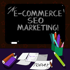 Writing note showing E Commerce Seo Marketing. Business photo showcasing Rise visibility of online store in search result Mounted Blackboard with Chalk Writing Tools Sheets on Desk