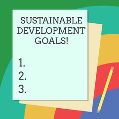 Word writing text Sustainable Development Goals. Business concept for Unite Nations Global vision for huanalysisity Stack of Blank Different Pastel Color Construction Bond Paper and Pencil