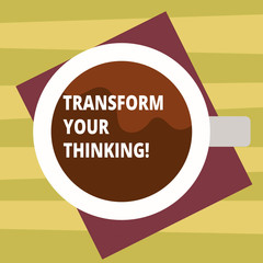 Text sign showing Transform Your Thinking. Conceptual photo Change your mind or thoughts towards things Top View of Drinking Cup Filled with Beverage on Color Paper photo