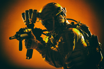 Army special operations soldier, commando fighter in full tactical ammunition, helmet with radio...