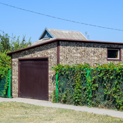 Car garage of corrugated metal profile.