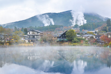 Yufuin town with hot spring smoke is seen from the other side of Lake Kinrin, Yufuin, Japan