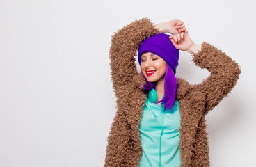 Beautiful young girl with purple hair in jacket on white background.