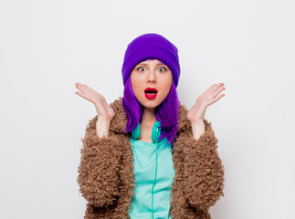 Beautiful young girl with purple hair in jacket on white background.