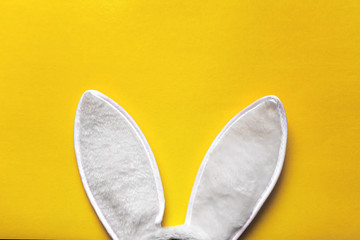 Rabbit ears on yellow background. Easter and holidays as a tradition.