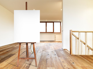 Painter's easel and empty canvas in a modern interior