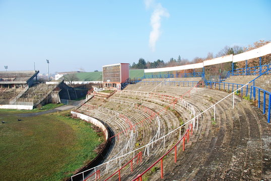 Empty tribunes of abandoned and decaying football stadium, urbex