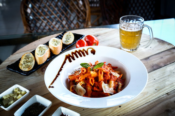 Pork with one glass of beer in wooden texture