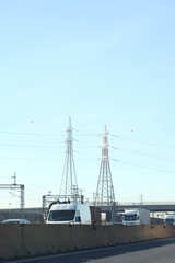 highway with trucks and eleitric trellis on the background