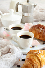 Breakfast with coffee and croissant