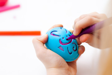 Yellow egg, colorful markers, Rabbit pattern, template for egg. Happy family is preparing for Easter and painting eggs