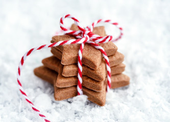 Christmas cookies - fresh baked star shaped biscuits on the snow.