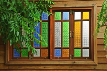 Stained glass window, thai style wooden window with green leaves. Interior and object concept.