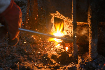 Welding machine with melting metal drops and sparks of sparks.