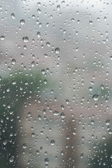 Rain drops on a window pane in a rainy day