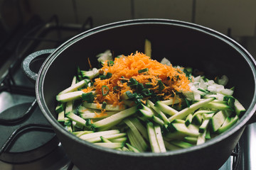 Domestic scene. cooking vegetables by the gas stove.