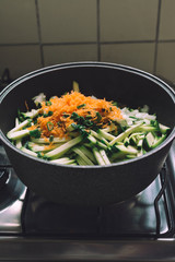 Domestic scene. cooking vegetables by the gas stove.
