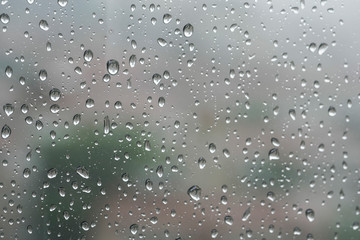 Rain drops on a window pane in a rainy day