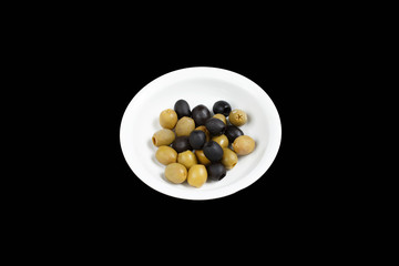 green and black olives in a plate on a black background