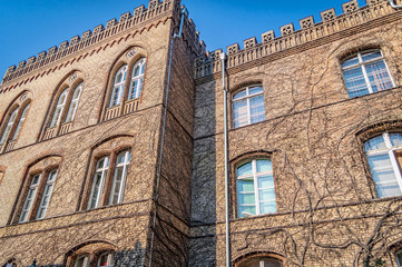 Climber on the old building, Torun, old city. Poland.