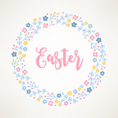 Easter wreath with flowers, branches and berries on beige background