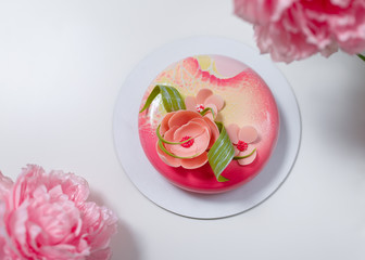pink round cake with flowers on the white background