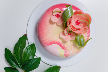 pink round cake with flowers on the white background