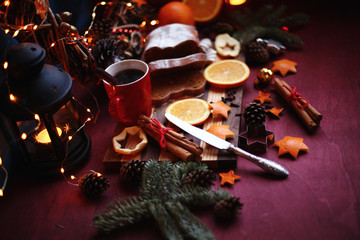 Christmas and New year background with Pie and a mug of coffee on the cutting board,oranges,Tree decorations ,lantern,  lights/top view/flat lay