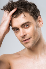 Obraz premium portrait of handsome young sexy man isolated on grey